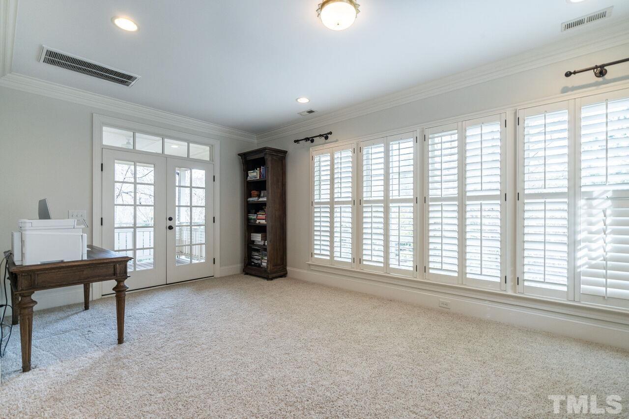 3056 Lewis Farm Road Raleigh, NC 27607 - Photo 22 of 43 a view of an empty room with a window and a kitchen