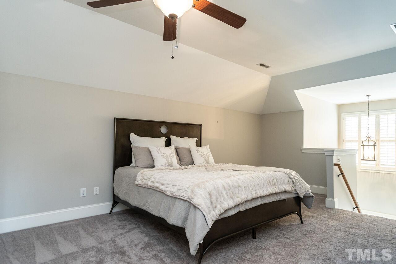 3056 Lewis Farm Road Raleigh, NC 27607 - Photo 33 of 43 a bedroom with a bed lamp and window