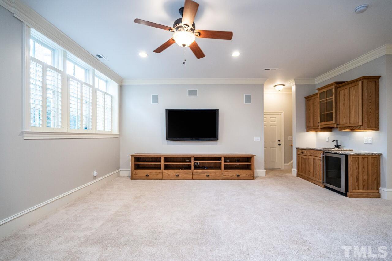 3056 Lewis Farm Road Raleigh, NC 27607 - Photo 37 of 43 a living room with furniture and a flat screen tv