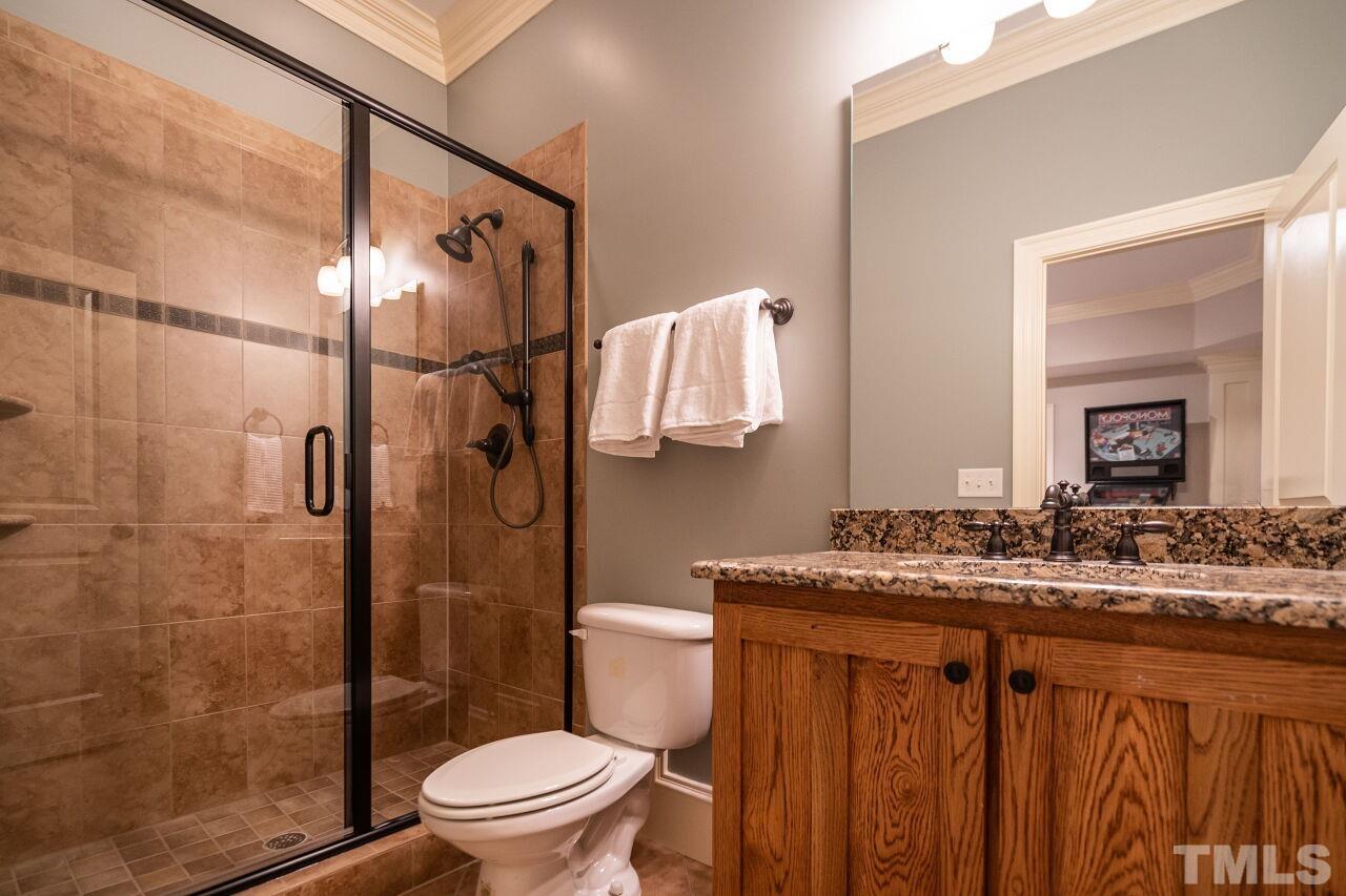 3056 Lewis Farm Road Raleigh, NC 27607 - Photo 38 of 43 a bathroom with a granite countertop sink toilet and shower