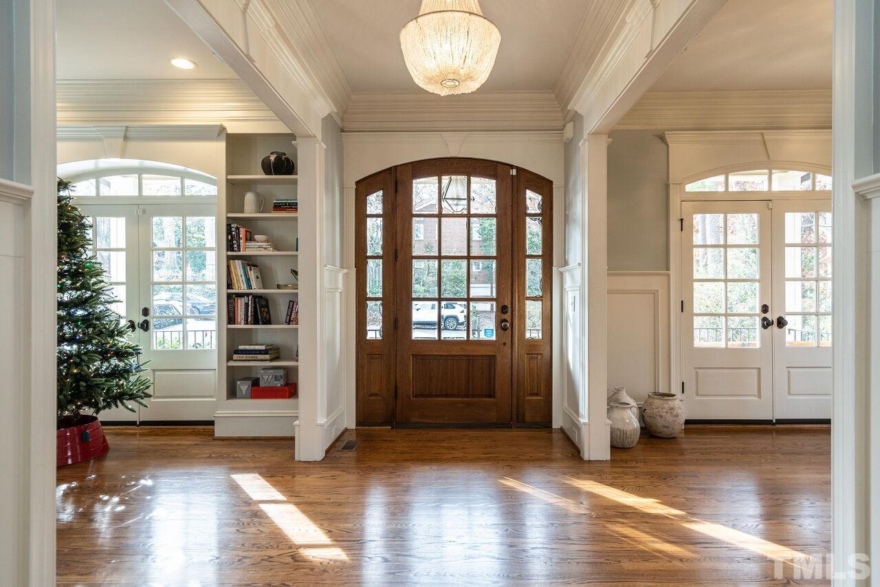 3056 Lewis Farm Road Raleigh, NC 27607 - Photo 4 of 43 an empty room with wooden floor and windows