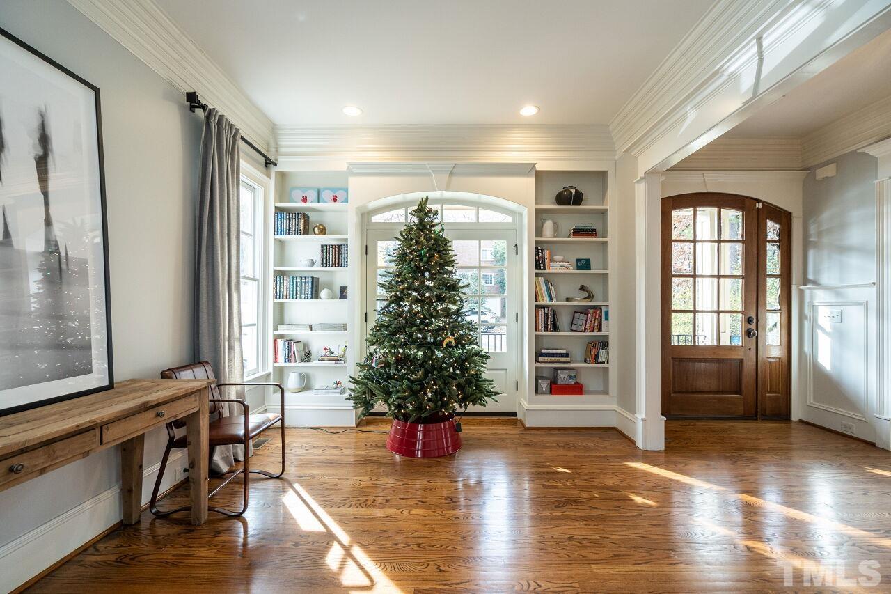 3056 Lewis Farm Road Raleigh, NC 27607 - Photo 5 of 43 a hallway with a large window and wooden floor