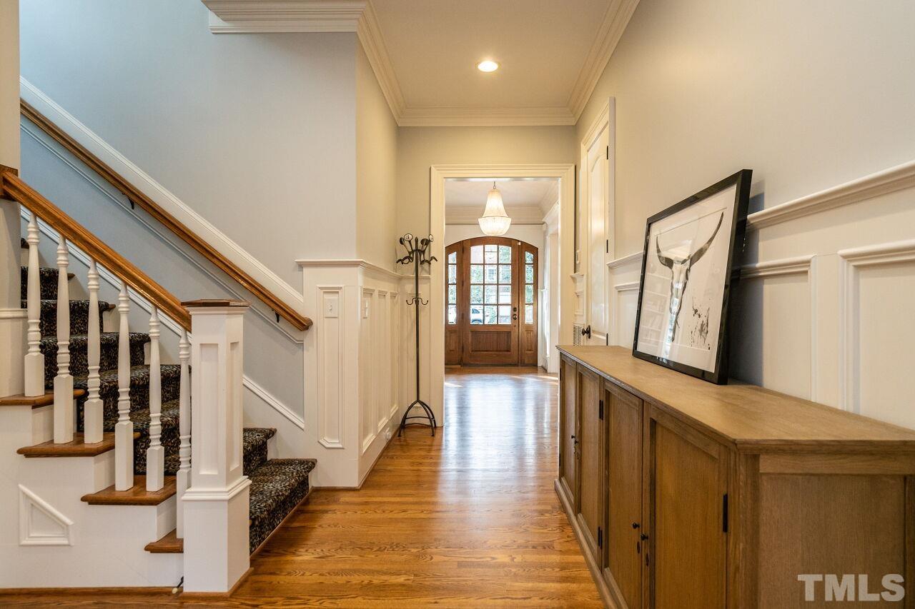 3056 Lewis Farm Road Raleigh, NC 27607 - Photo 8 of 43 a view of a hallway with wooden floor and staircase