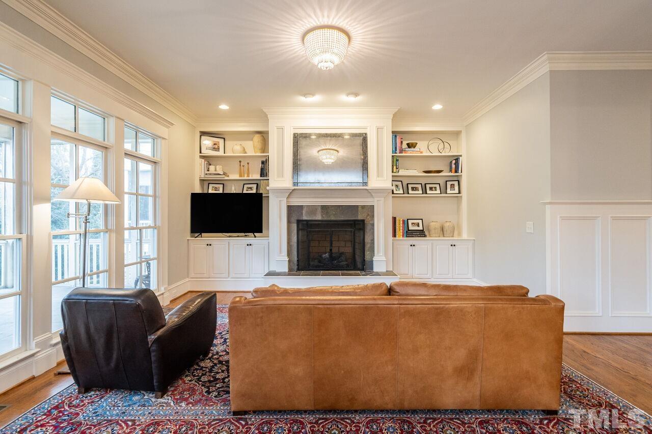 3056 Lewis Farm Road Raleigh, NC 27607 - Photo 10 of 43 a living room with furniture a flat screen tv and a fireplace