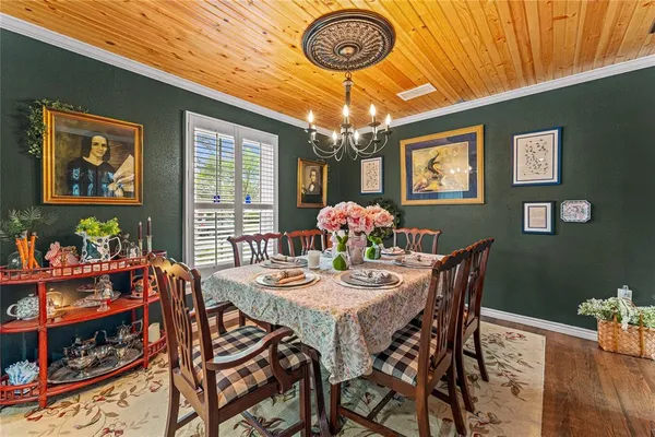 a view of a dining room with furniture and chandelier
