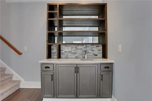 a kitchen with white cabinets stainless steel appliances and sink