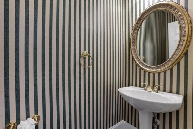 a spacious bathroom with a sink mirror and a bathtub