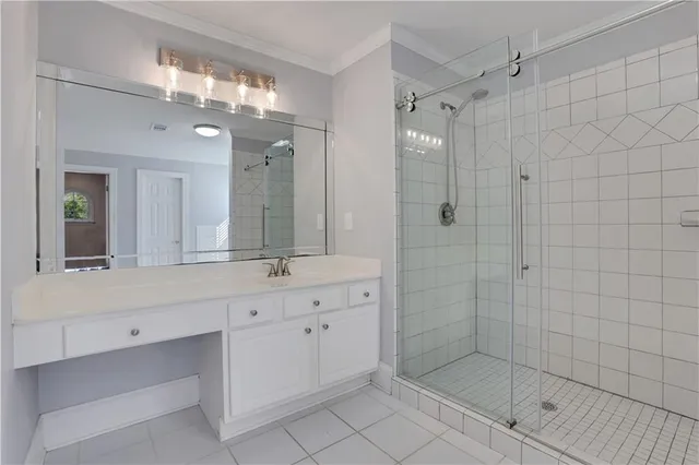 a view of an empty room with window and chandelier fan