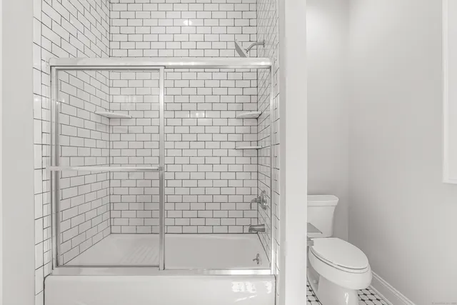 a bathroom with a shower and a toilet
