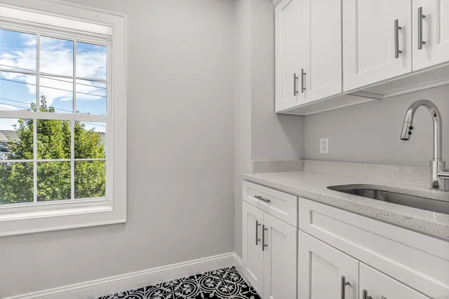 a kitchen with white cabinets and a sink