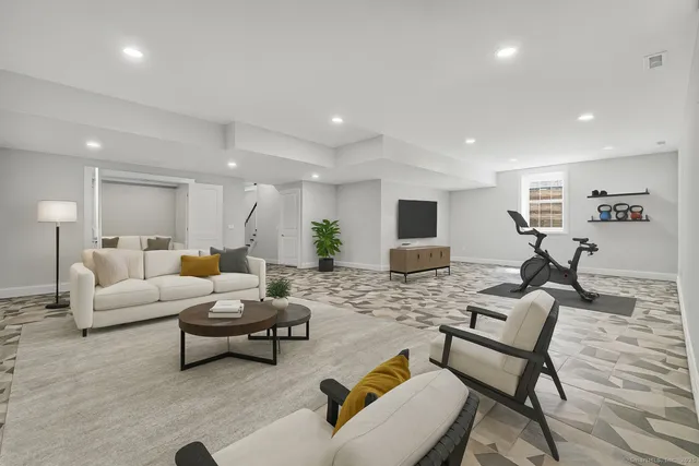 a living room with furniture and a flat screen tv