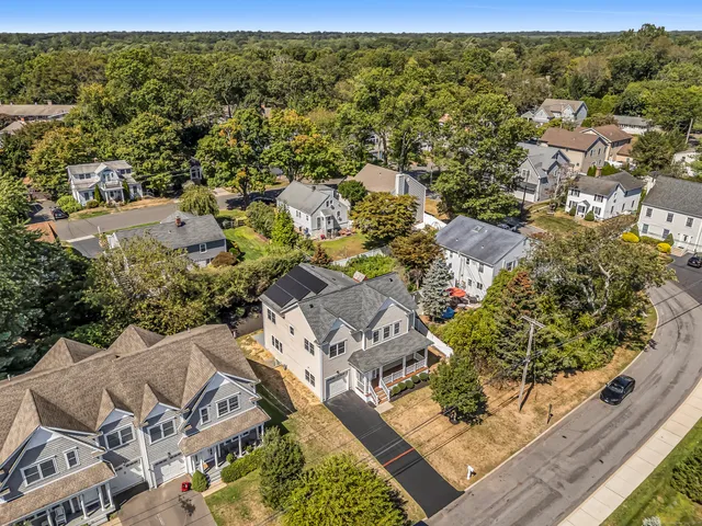 an aerial view of residential houses with outdoor space