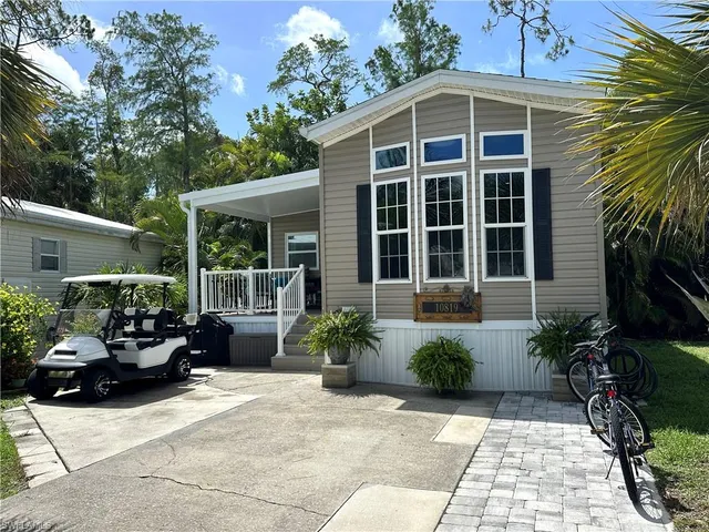 a view of a house with sitting area and potted plants