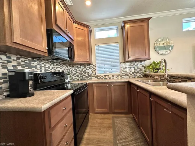 a kitchen with stainless steel appliances granite countertop a sink and a stove