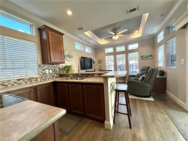 a kitchen with stainless steel appliances granite countertop wooden floors stove top oven and sink