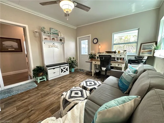 a living room with furniture and wooden floor