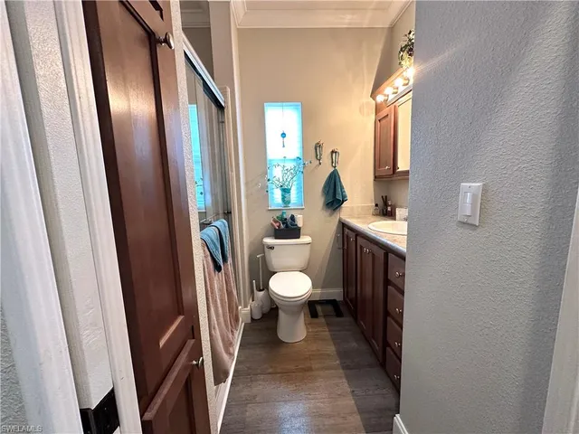 a bathroom with a toilet a sink a mirror and a shower