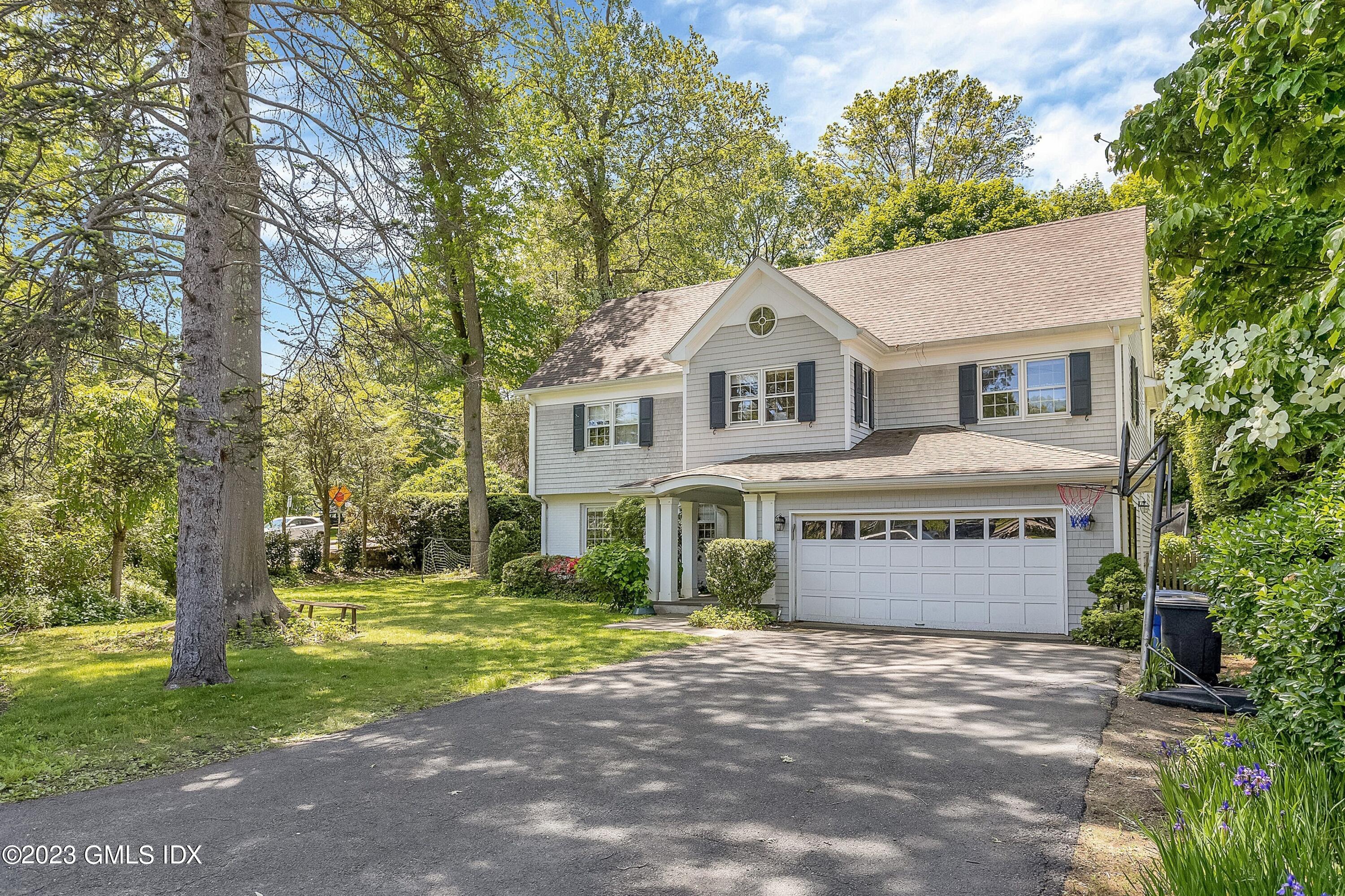 4 Bramble Lane Riverside, CT 06878 - Photo 4 of 19 a front view of a house with a garden