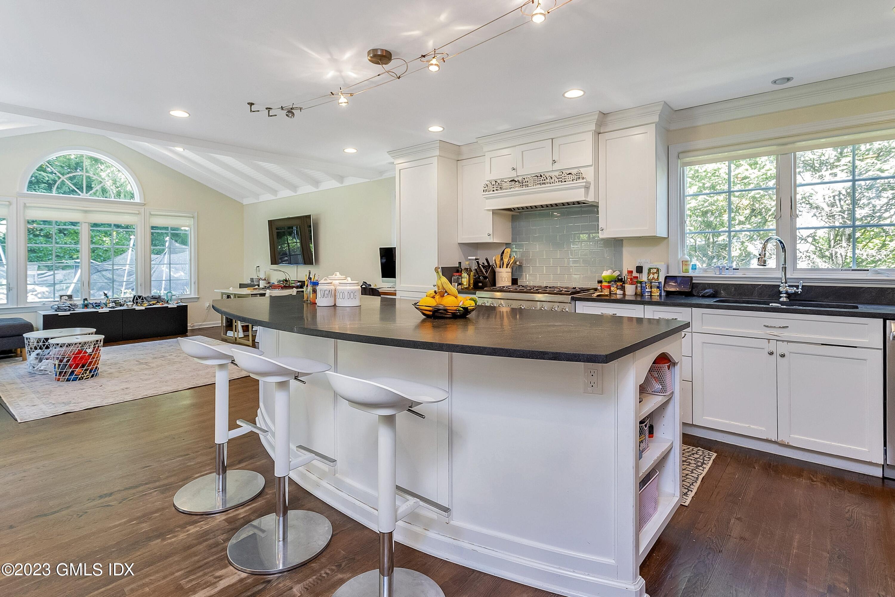 4 Bramble Lane Riverside, CT 06878 - Photo 6 of 19 a kitchen with a sink a counter top space and stainless steel appliances