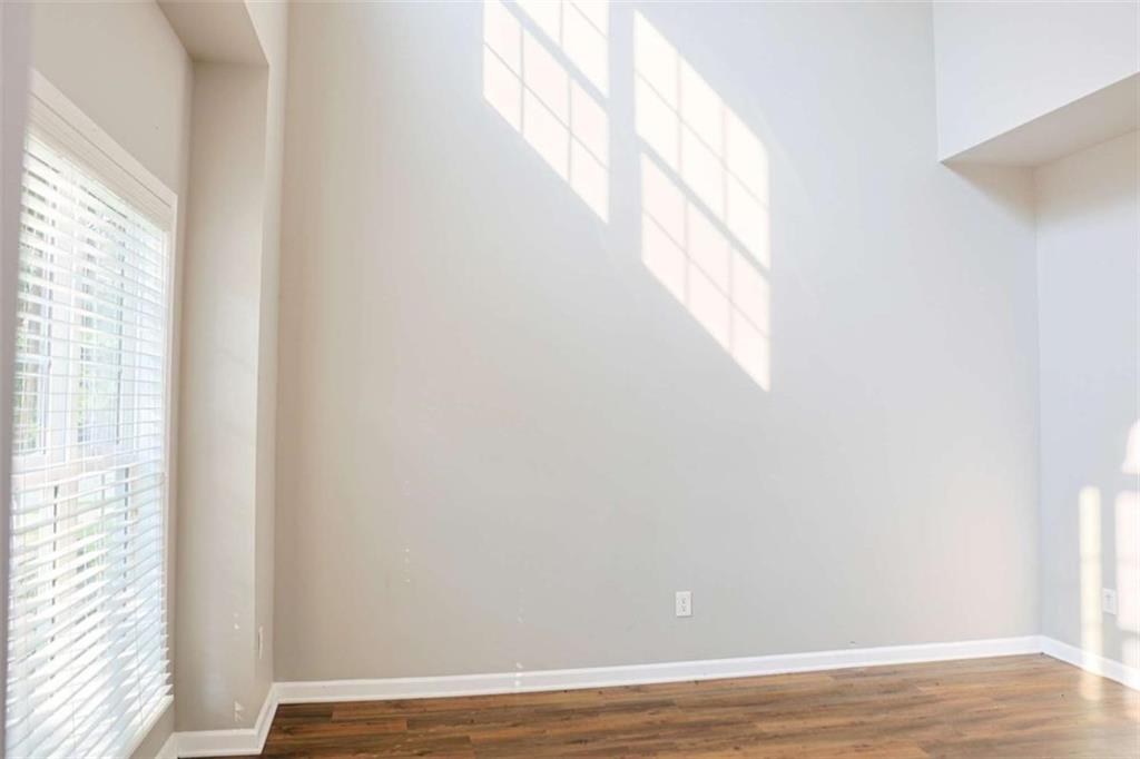 910 Lakeside Court Loganville, GA 30052 - Photo 14 of 57 a view of a small space with wooden floor and a window