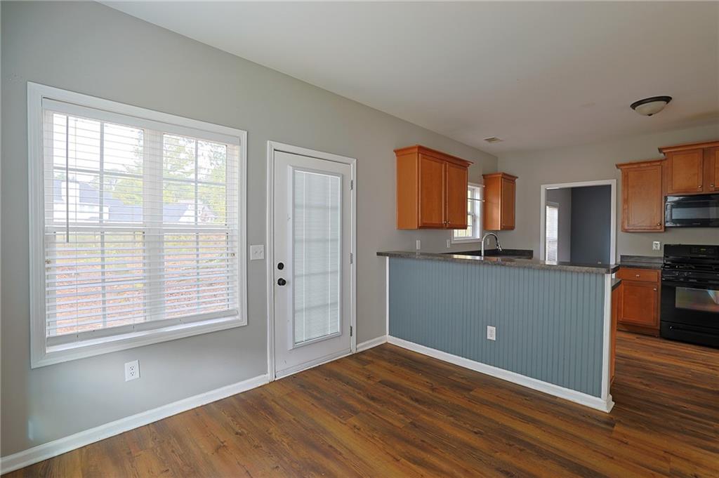 910 Lakeside Court Loganville, GA 30052 - Photo 27 of 57 a view of kitchen with wooden floor and electronic appliances