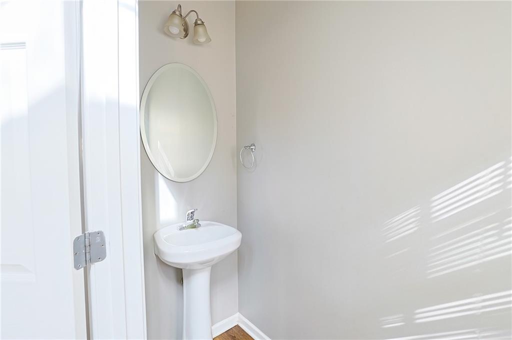 910 Lakeside Court Loganville, GA 30052 - Photo 36 of 57 a bathroom with a sink and a mirror