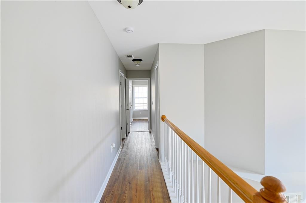 910 Lakeside Court Loganville, GA 30052 - Photo 38 of 57 a view of a hallway with wooden floor