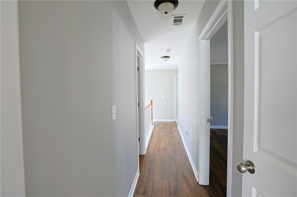 910 Lakeside Court Loganville, GA 30052 - Photo 39 of 57 a view of a hallway with wooden floor