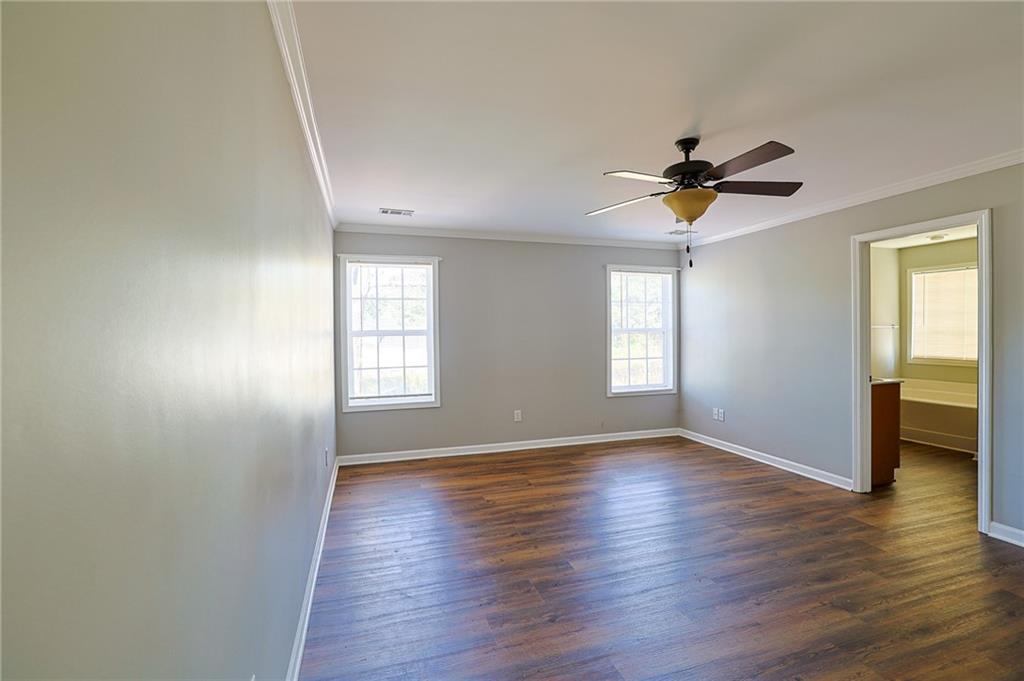 910 Lakeside Court Loganville, GA 30052 - Photo 41 of 57 an empty room with wooden floor and windows