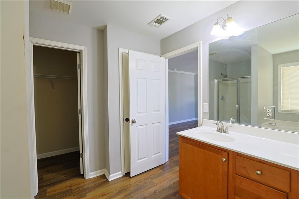 910 Lakeside Court Loganville, GA 30052 - Photo 46 of 57 a bathroom with a sink and a mirror