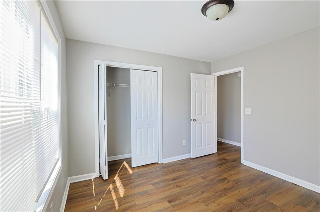 910 Lakeside Court Loganville, GA 30052 - Photo 54 of 57 an empty room with wooden floor and windows