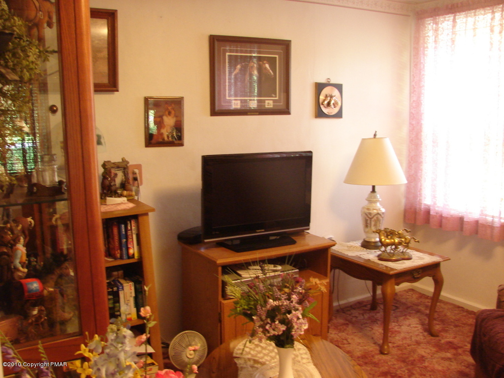 1497 Clearfield Road Nazareth, PA 18064 - Photo 3 of 13 a living room with furniture and a flat screen tv