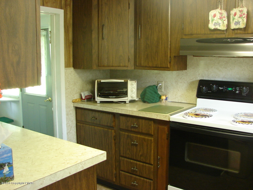 1497 Clearfield Road Nazareth, PA 18064 - Photo 4 of 13 a kitchen with a sink a stove and cabinets