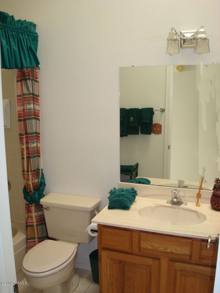9985 North Desert Sky Road Oro Valley, AZ 85737 - Photo 29 of 43 a bathroom with a sink a toilet and shower