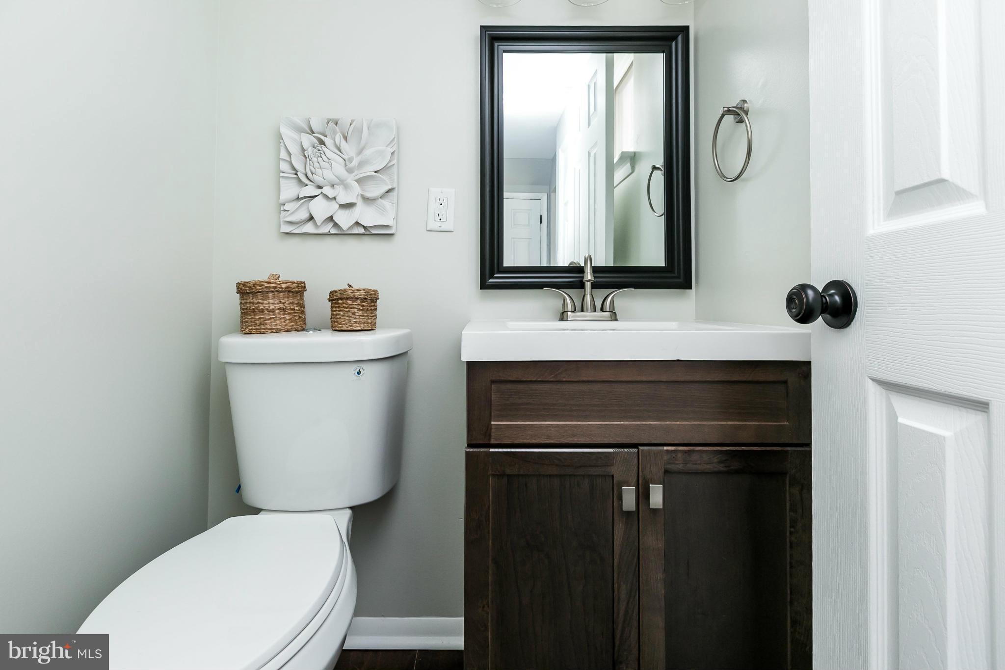 4527 Tapscott Road Baltimore, MD 21208 - Photo 15 of 30 a bathroom with a toilet sink and mirror