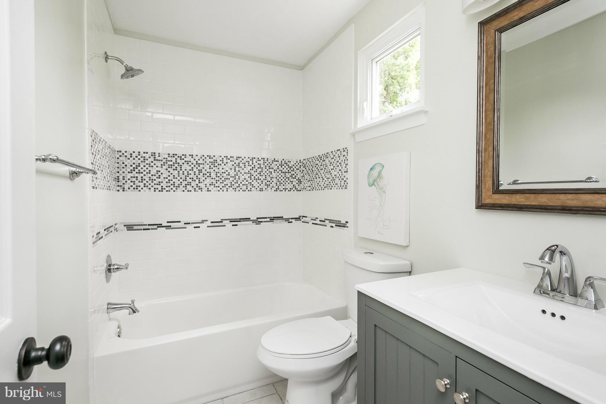 4527 Tapscott Road Baltimore, MD 21208 - Photo 16 of 30 a bathroom with a sink a toilet and shower