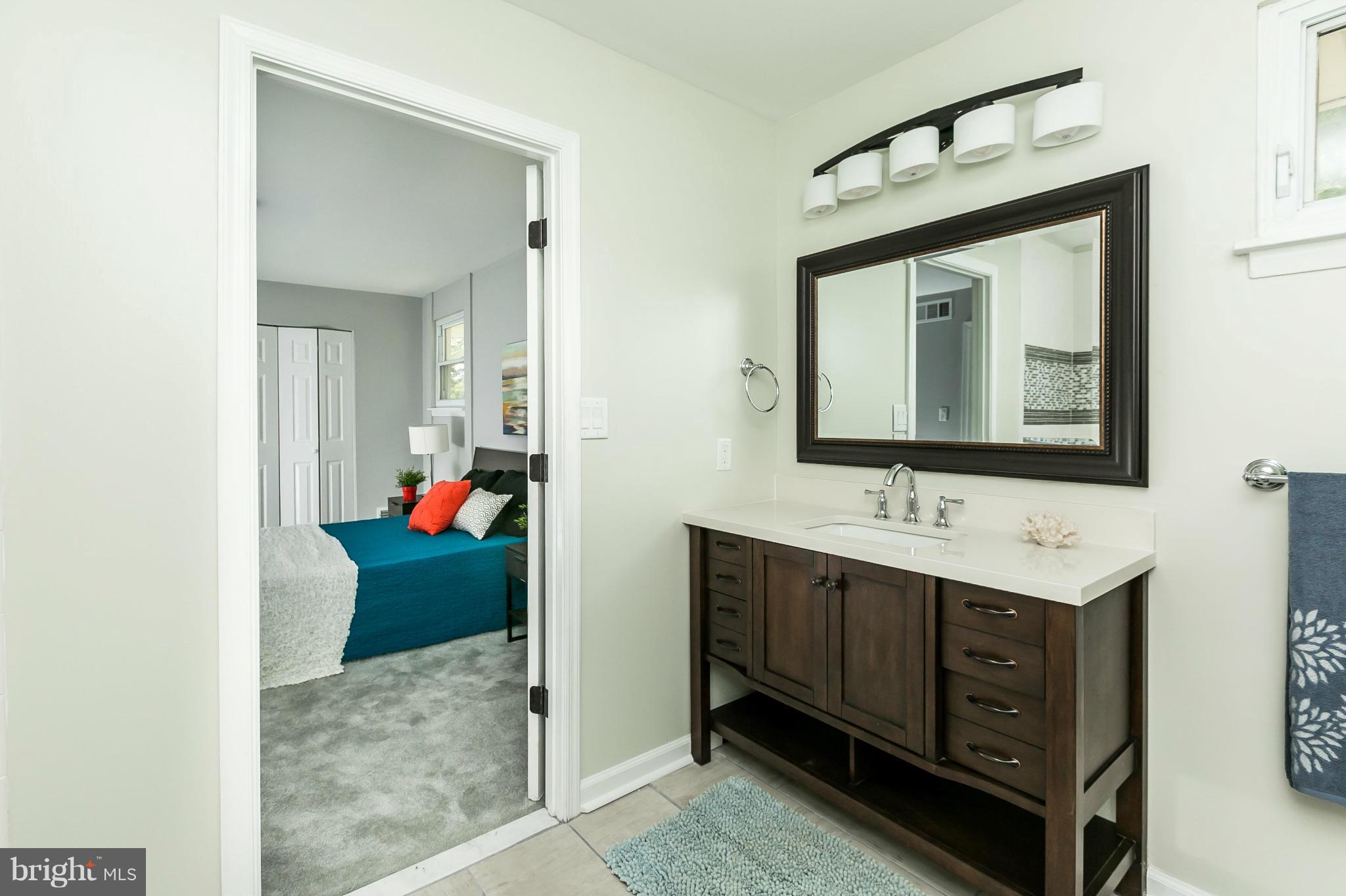 4527 Tapscott Road Baltimore, MD 21208 - Photo 21 of 30 a bathroom with a toilet sink and mirror
