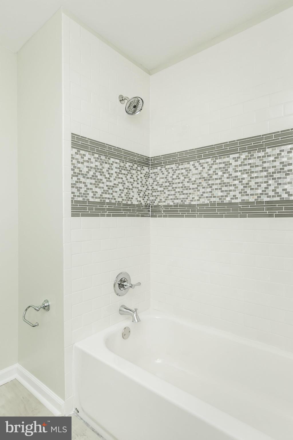 4527 Tapscott Road Baltimore, MD 21208 - Photo 22 of 30 a bathroom with a bathtub and a shower