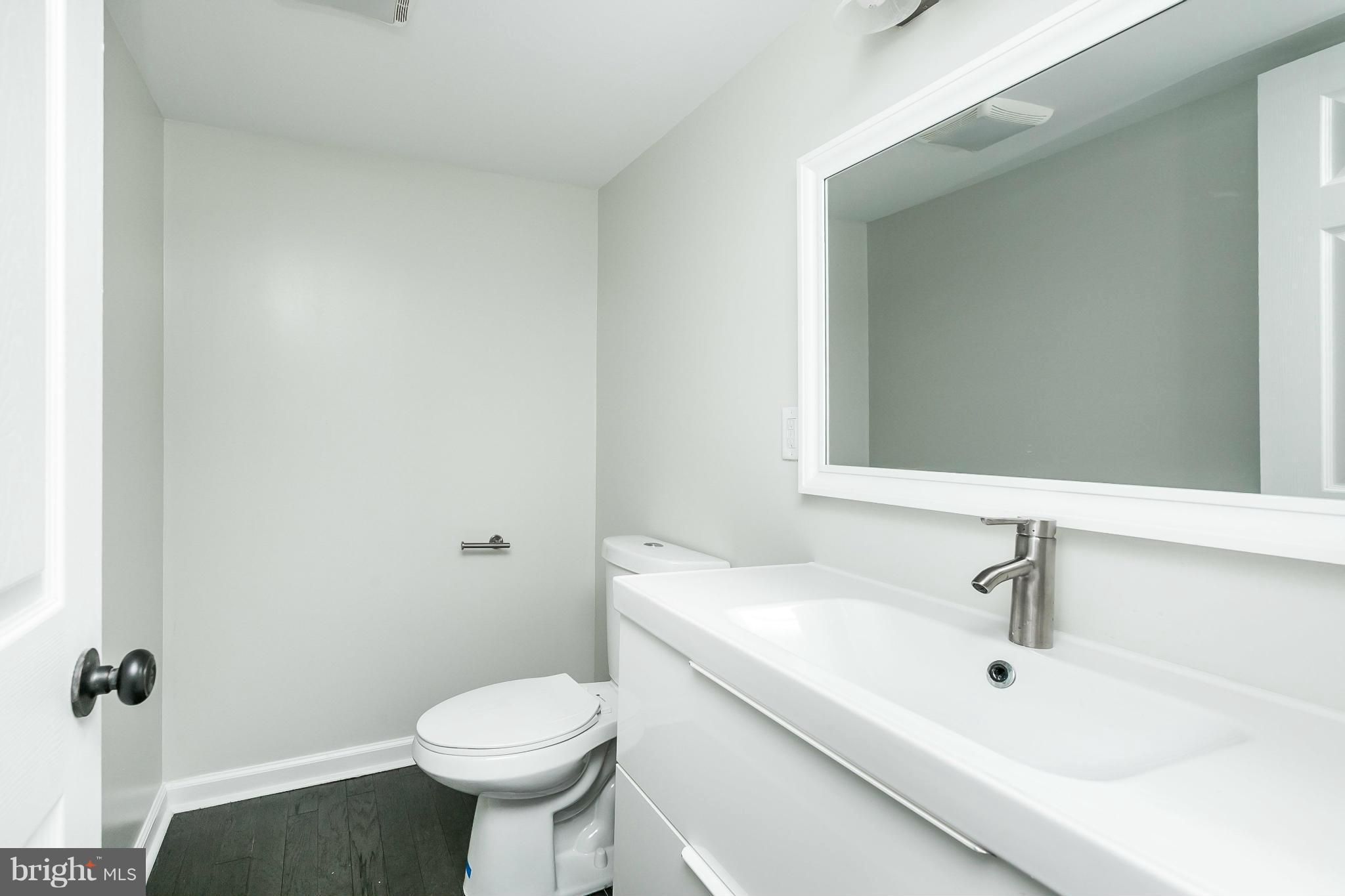 4527 Tapscott Road Baltimore, MD 21208 - Photo 24 of 30 a bathroom with a sink toilet and a mirror