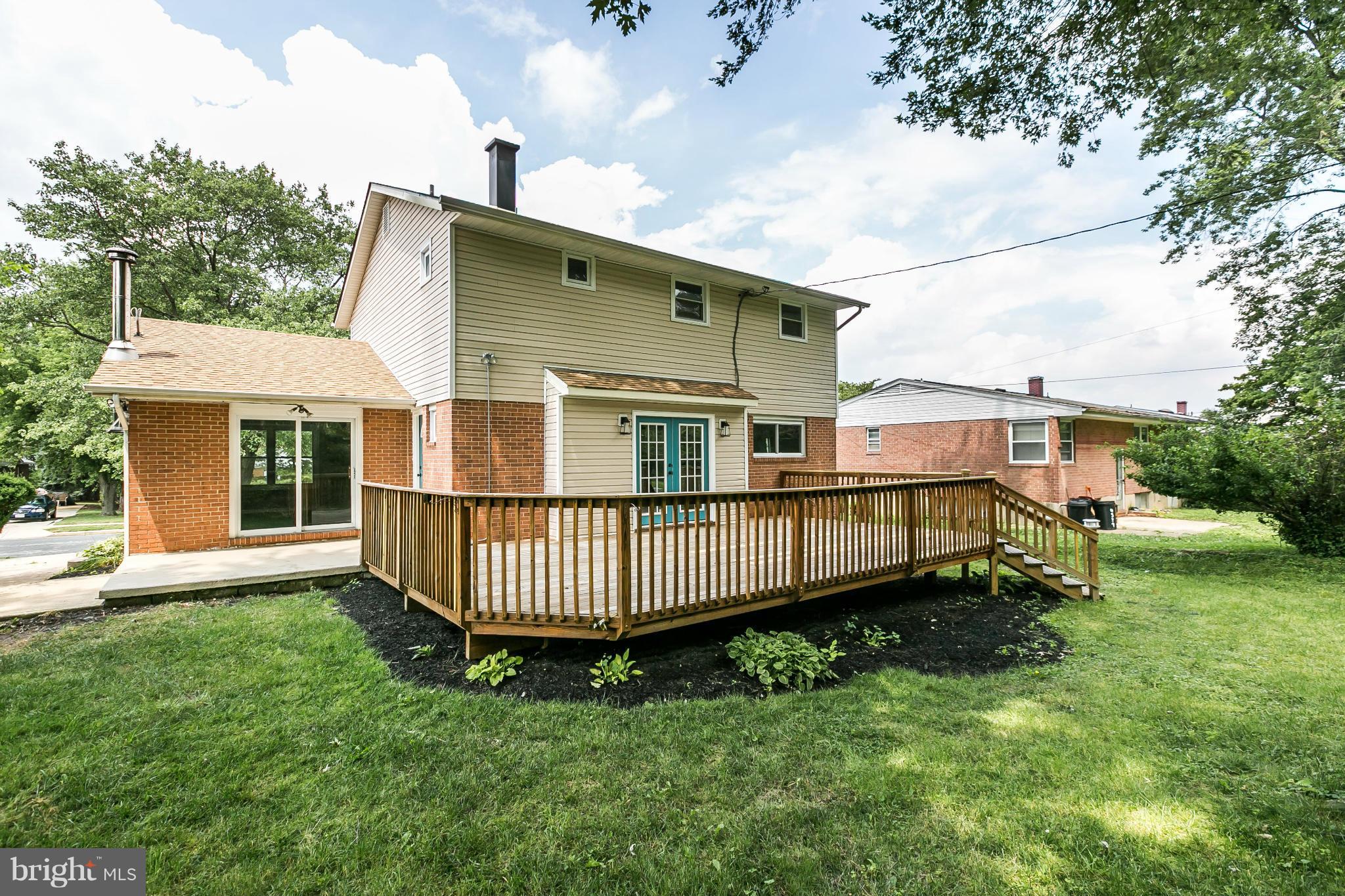 4527 Tapscott Road Baltimore, MD 21208 - Photo 25 of 30 a view of a house with a yard and deck