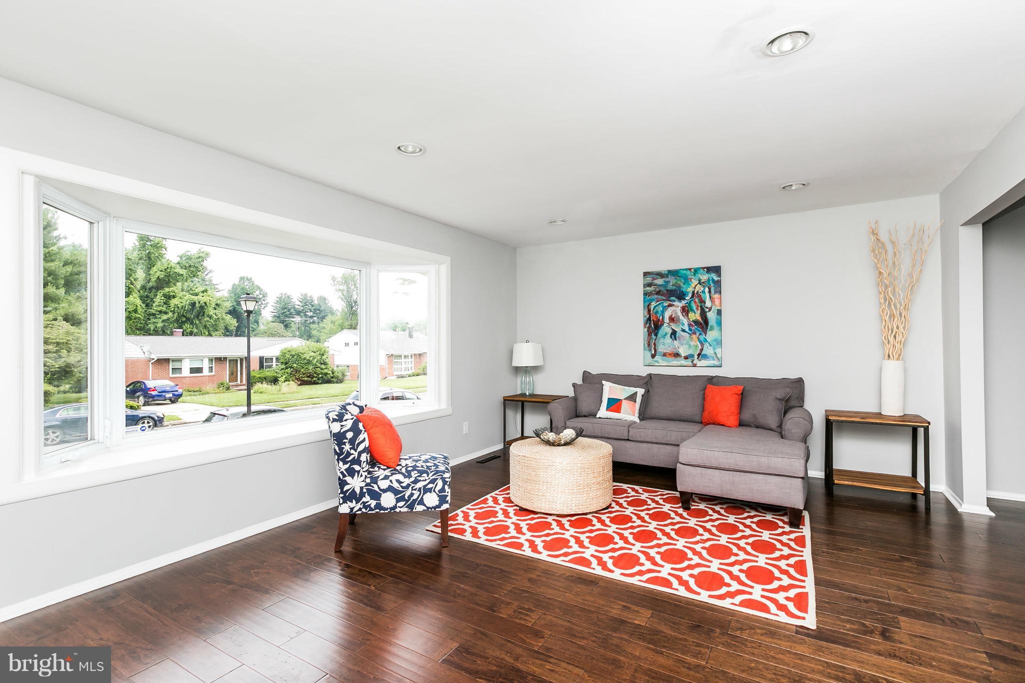 4527 Tapscott Road Baltimore, MD 21208 - Photo 5 of 30 a living room with furniture and a wooden floor