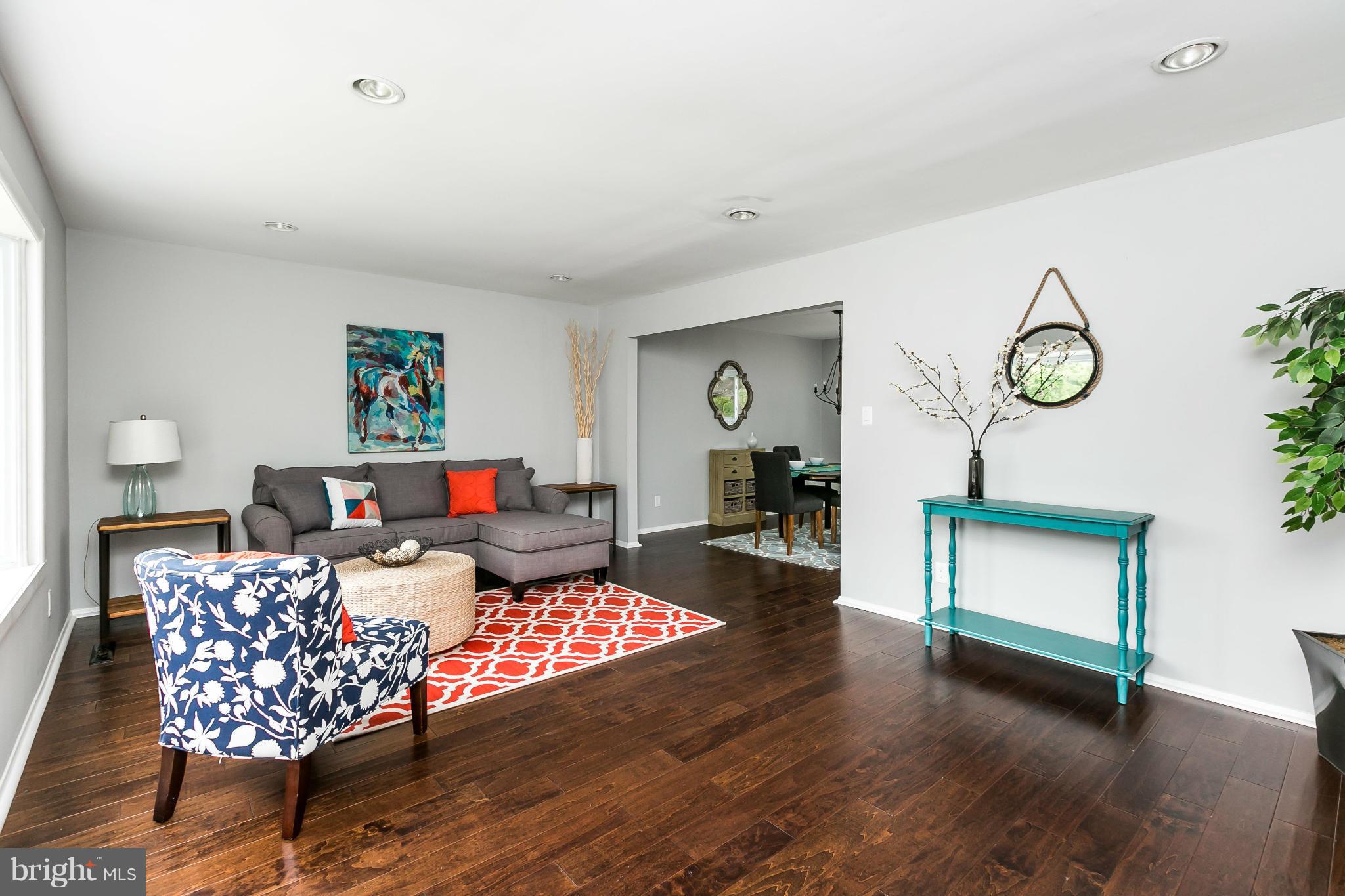 4527 Tapscott Road Baltimore, MD 21208 - Photo 7 of 30 a living room with furniture a rug and a wall