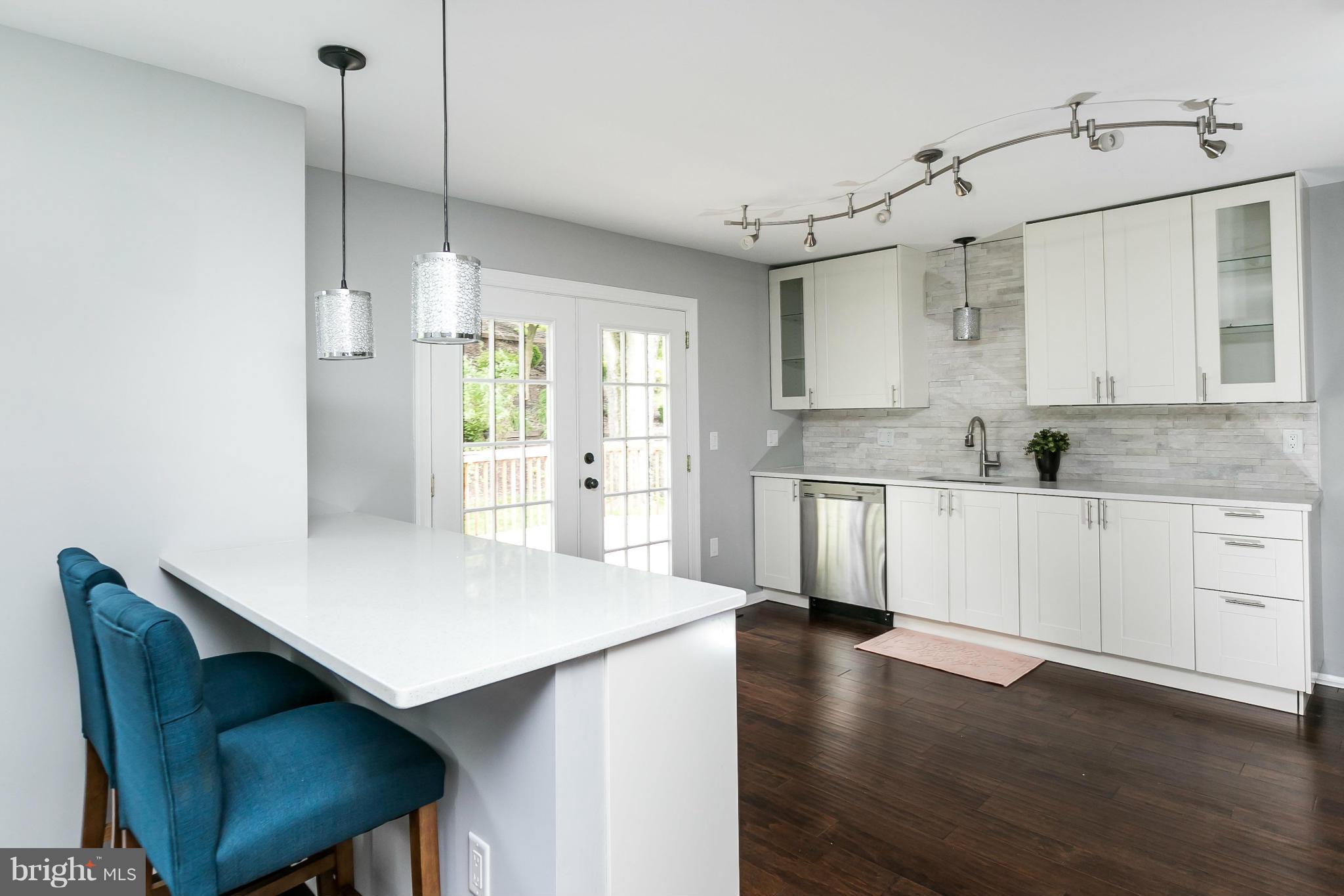 4527 Tapscott Road Baltimore, MD 21208 - Photo 10 of 30 a kitchen with cabinets and wooden floor