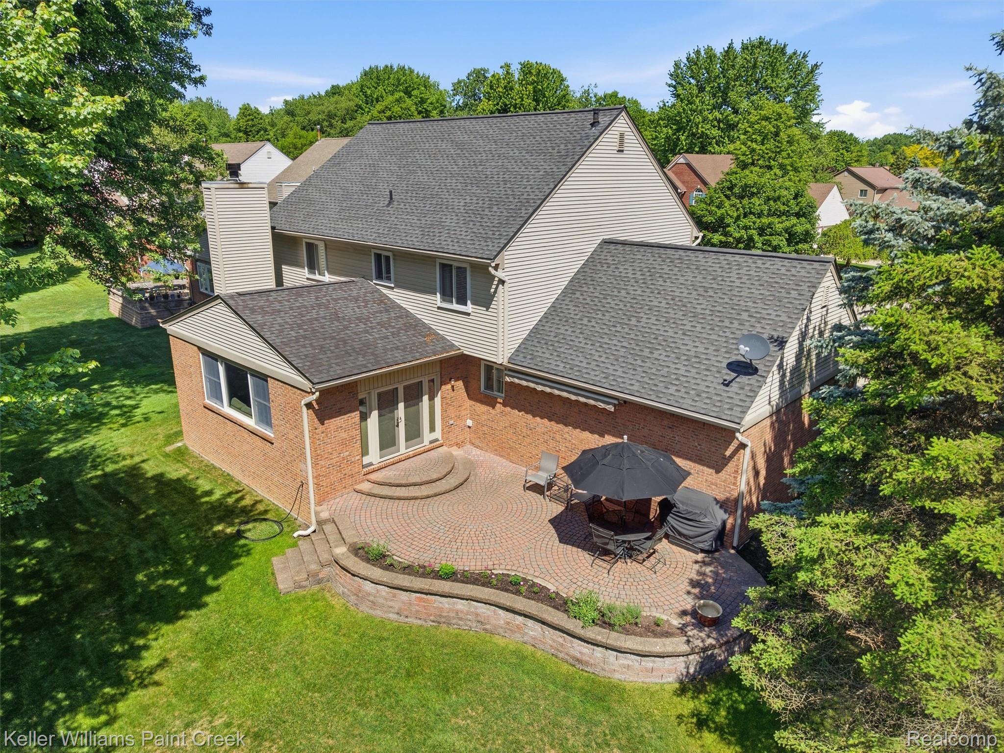 2842 Manorwood Road Troy, MI 48085 - Photo 15 of 72 Expansive brick paver patio featuring a curved retaining wall and direct access to the interior