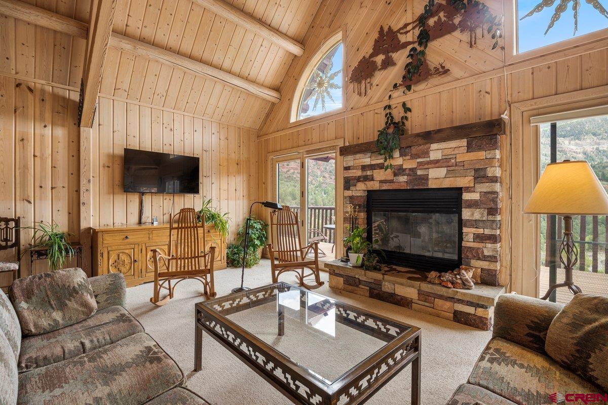 2490 County Road 17 Ridgway, CO 81432 - Photo 13 of 26 a living room with furniture a fireplace and a flat screen tv