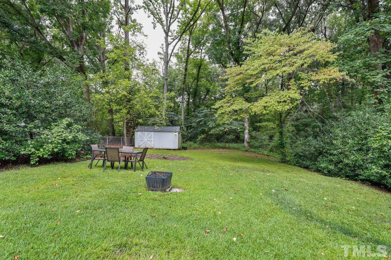 1306 Valley Road Garner, NC 27529 - Photo 15 of 18 a backyard of a house with table and chairs