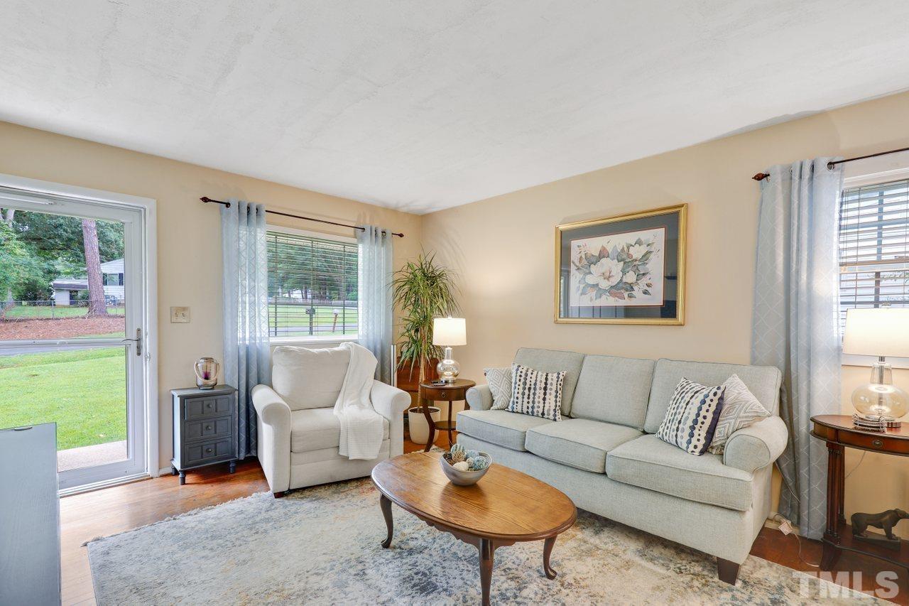 1306 Valley Road Garner, NC 27529 - Photo 2 of 18 a living room with furniture and a large window