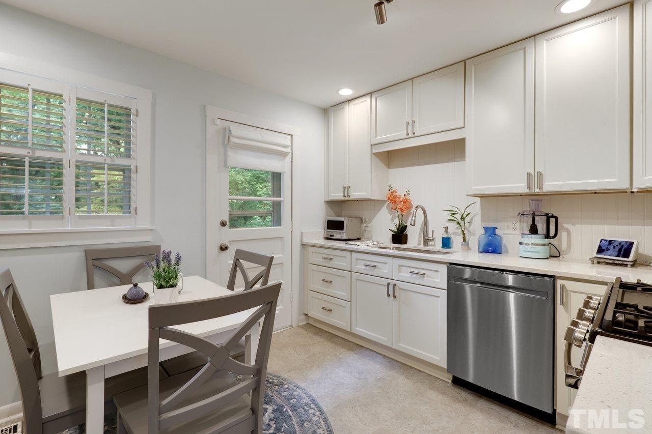 1306 Valley Road Garner, NC 27529 - Photo 4 of 18 a kitchen with a dining table chairs and window