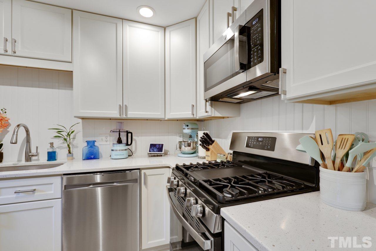 1306 Valley Road Garner, NC 27529 - Photo 5 of 18 a kitchen with stainless steel appliances granite countertop a sink stove and cabinets