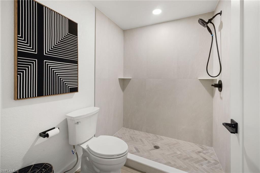 4521 3rd Avenue Northwest Naples, FL 34119 - Photo 36 of 46 a bathroom with a toilet and a shower